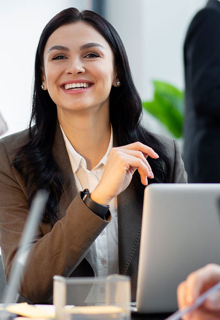close-up-smiley-woman-working-1-704x1024