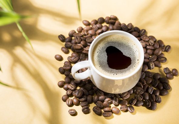 Colombian Coffee Break: Cup of Joe on a Yellow Background with Natural Shadows
