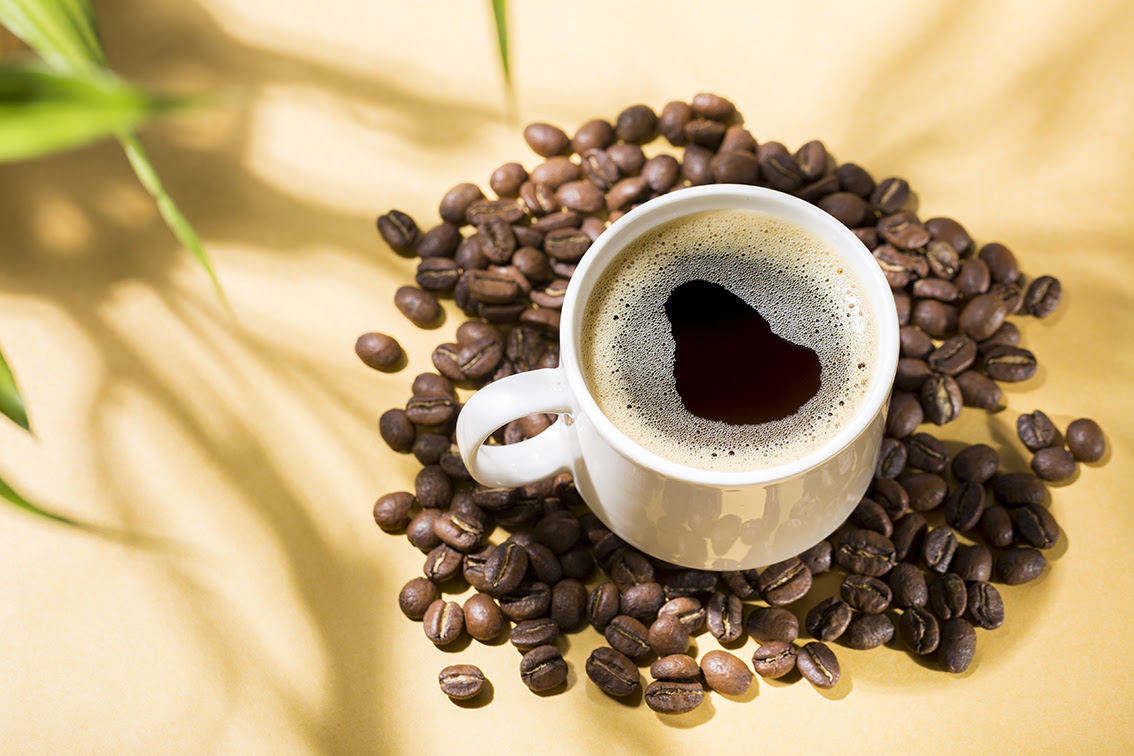Colombian Coffee Break: Cup of Joe on a Yellow Background with Natural Shadows