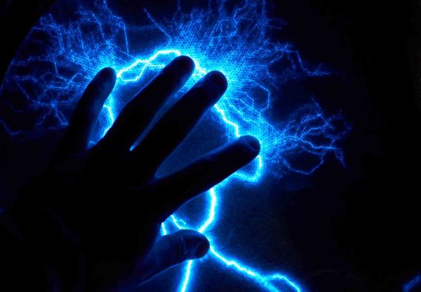 Electric plasma ball on dark background. Static electricity model
