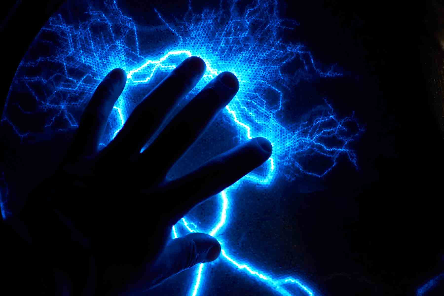 Electric plasma ball on dark background. Static electricity model